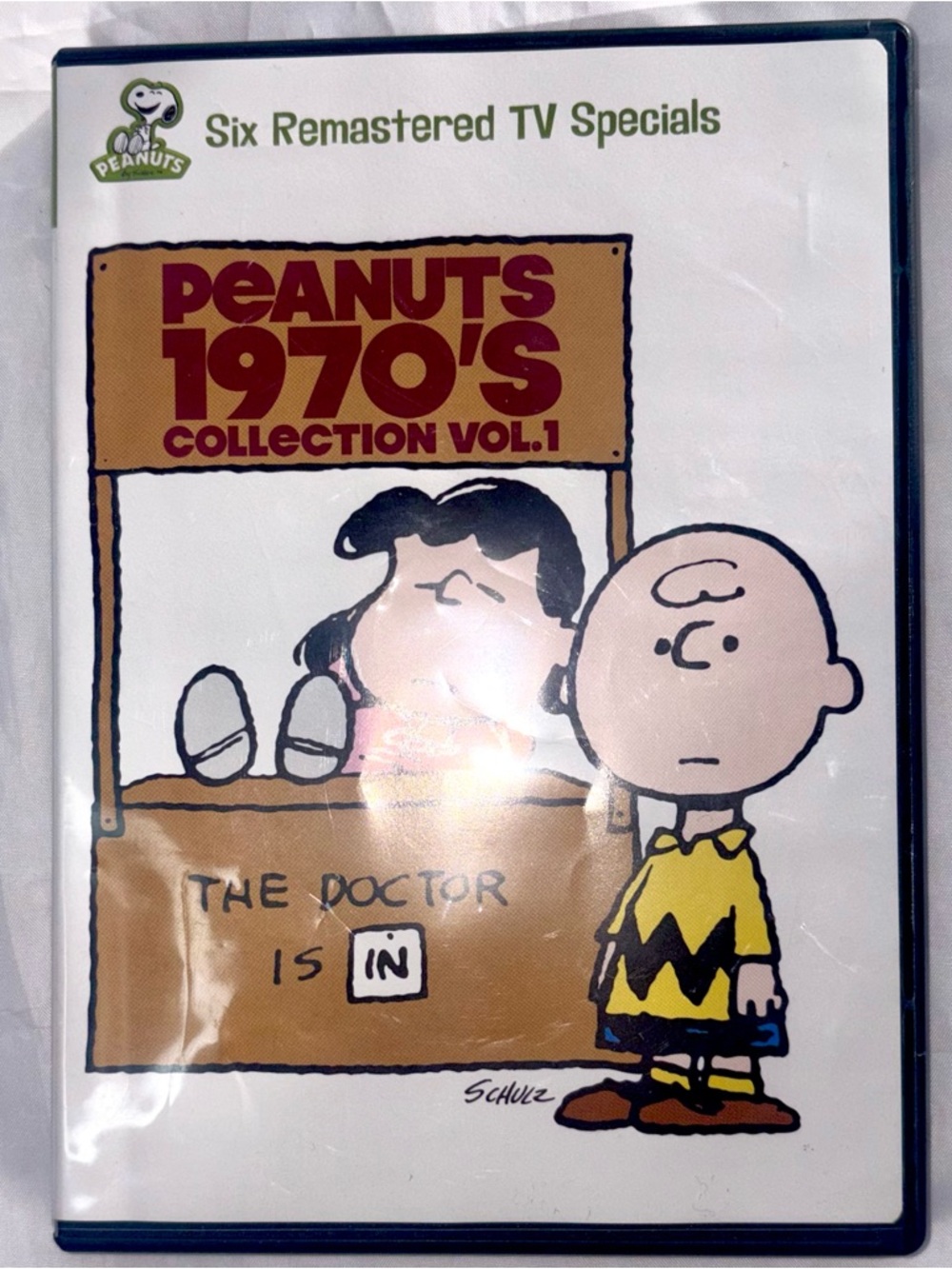 Peanuts DVD with Brown, Pink and Blue Cartoon Cover